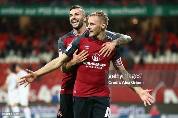 Hanno Behrens of Nuernberg celebrates his team's second goal with team mate Mikael Ishak during the Second Bundesliga match between 1. FC Nuernberg...