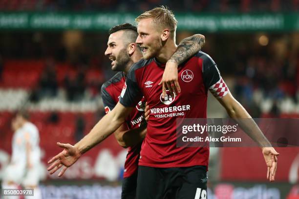 Hanno Behrens of Nuernberg celebrates his team's second goal with team mate Mikael Ishak during the Second Bundesliga match between 1. FC Nuernberg...