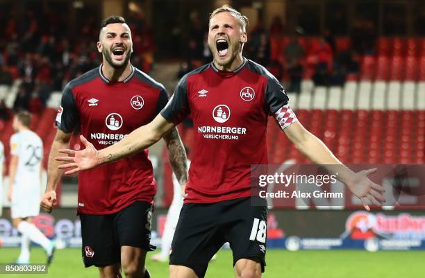 Hanno Behrens of Nuernberg celebrates his team's second goal with team mate Mikael Ishak during the Second Bundesliga match between 1. FC Nuernberg...