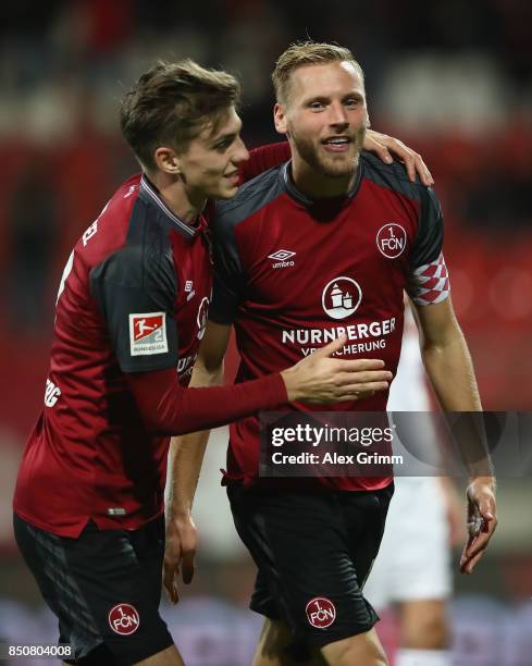 Hanno Behrens of Nuernberg celebrates his team's second goal with team mate Lucas Hufnagel during the Second Bundesliga match between 1. FC Nuernberg...