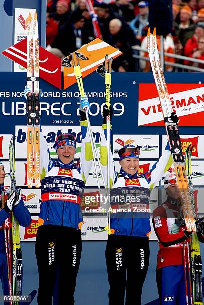 Virpi Kuitunen of Finland and Aino-Kaisa Saarinen of Finland take 1st place in the FIS Nordic World Ski Championships Cross Country Ladies Free Team...