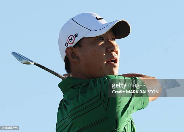 Anthony Kim of the US watches his tee shot at the 3rd hole during his matchplay round against Lin Wen-Tang of Taiwan on the first day of the...