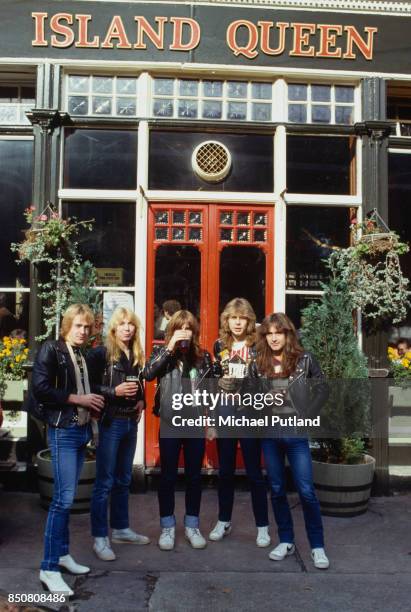 English heavy metal group Iron Maiden outside the Island Queen pub in Islington, London, 1982. Left to right: guitarist Adrian Smith, guitarist Dave...