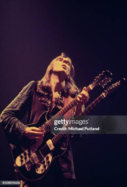 English musician Mike Rutherford of rock group Genesis performs on stage, April 1976.