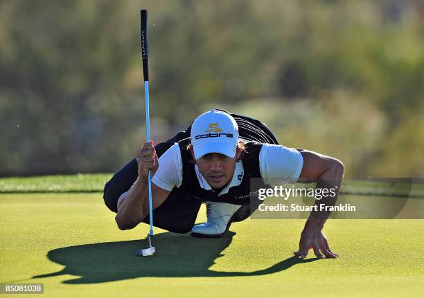 Camilo Villegas of Colombia lines up a putt on the first green during the first round of the Accenture Match Play Championship at the Ritz-Carlton...