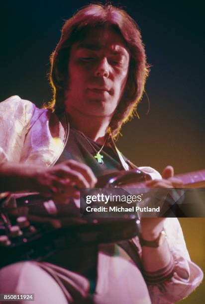 English musician and songwriter Steve Hackett of rock group Genesis performs on stage, 1976.