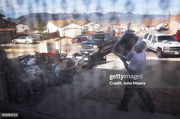 An eviction team removes furniture from a home that was being forclosed upon February 25, 2009 in Security, Colorado. The owners had stopped making...