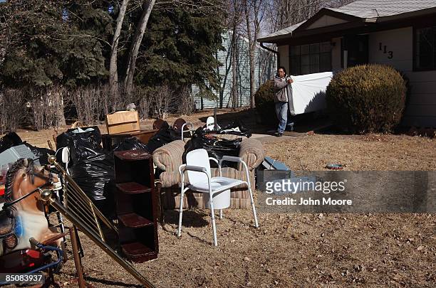 Houshold items of a deceased resident are put out on the front lawn of a foreclosed house February 25, 2009 in Security, Colorado. The elderly...