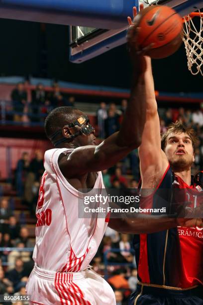 Sow Pape, #8 of AJ Milano competes with Tiago Splitter, #21 of TAU Ceramica during the Euroleague Basketball Last 16 Game 4 match between Armani...