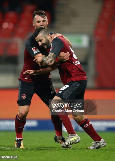 Mikael Ishak of Nuernberg celebrates his team's third goal with team mate Eduard Loewen during the Second Bundesliga match between 1. FC Nuernberg...