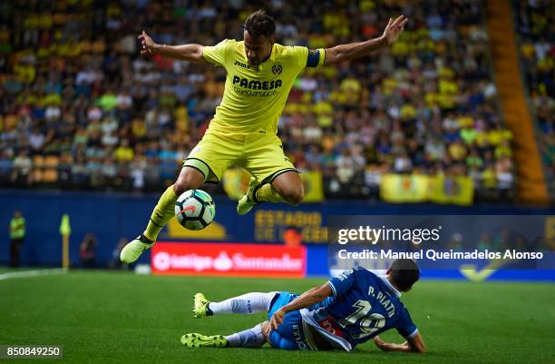 Mario Gaspar of Villarreal is tackled by Pablo Piatti of Espanyol during the La Liga match between Villarreal and Espanyol at Estadio De La Ceramica...