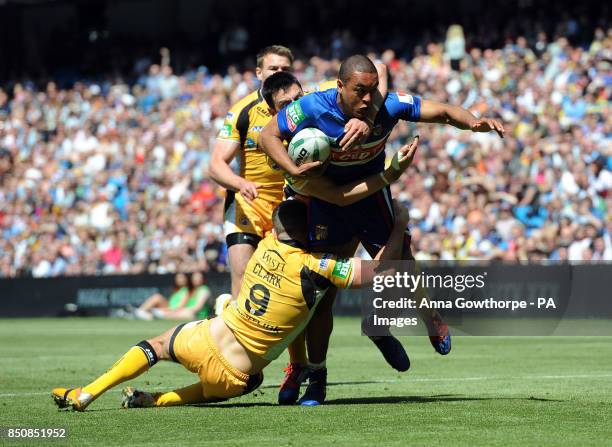 Wakefield Wildcats' Reece Lyne is tackled by Castleford Tigers' Daryl Clark during the Super League Magic Weekend at the Etihad Stadium, Manchester.