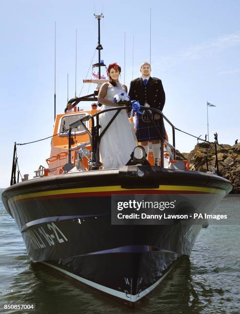 Royal National Lifeboat Institution volunteers John Connor and Kirstyn Howle as they marry each other on the Portpatrick lifeboat RNLB John Buchanan...