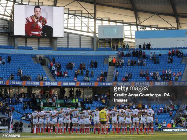 The St Helens team stand together during a minute's silence held for murdered soldier Lee Rigby during the Super League Magic Weekend at the Etihad...