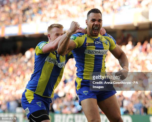 Warrington Wolves' Ryan Atkins celebrates with Chris Riley after scoring a try during the Super League Magic Weekend at the Etihad Stadium,...