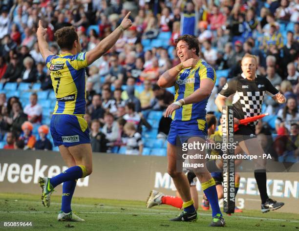 Warrington Wolves' Trent Waterhouse celebrates with Richie Myler after scoring a try during the Super League Magic Weekend at the Etihad Stadium,...