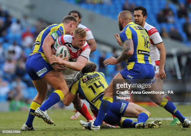 St Helens' Louie McCarthy-Scarsbrook is tackled by warrington Wolves' Ben Currie and Micky Higham during the Super League Magic Weekend at the Etihad...