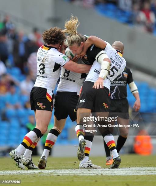 Huddersfield Giants' Eorl Crabtree is tackled by Bradford Bulls' Jamie Langley and Chev Walker during the Super League Magic Weekend at the Etihad...