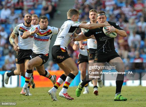 Huddersfield Giants' Shaun Lunt is tackled by Bradford Bulls' Jamie Foster during the Super League Magic Weekend at the Etihad Stadium, Manchester.
