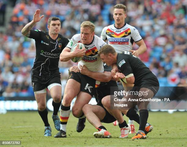 Bradford Bulls' Tom Olbison tries to force his way through the Huddersfield Giants' defence during the Super League Magic Weekend at the Etihad...