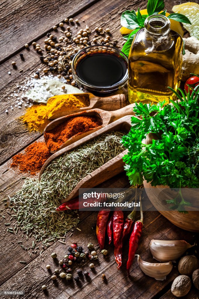 Spices and herbs on wooden kitchen table