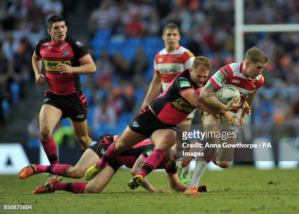 Wigan Warriors' Sam Tomkins is tackled by Leeds Rhinos' Paul McShane during the Super League Magic Weekend at the Etihad Stadium, Manchester.