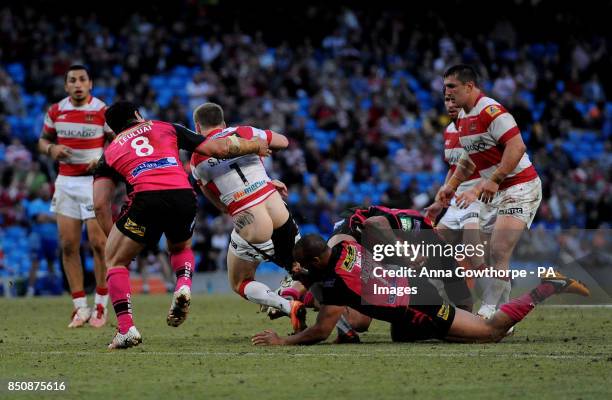 Wigan Warriors' Sam Tomkins loses his shorts in a tackle from Leeds Rhinos' Jamie Jones-Buchanan during the Super League Magic Weekend at the Etihad...