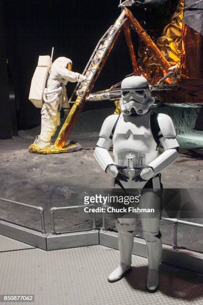 An actor, in costume as a 'stormtrooper' from the 'Star Wars' films, poses beside a display of NASA's Grumman Lunar Module LM-13 at the Cradle of...