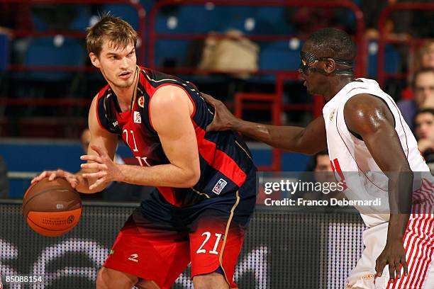 Tiago Splitter, #21 of TAU Ceramica competes with Sow Pape, #8 of AJ Milano during the Euroleague Basketball Last 16 Game 4 match between Armani...