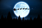 Santa flying over night sky