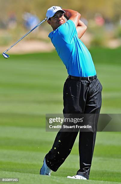 Tiger Woods of the USA plays his approach shot on the second hole during the first round of the Accenture Match Play Championships at Ritz - Carlton...