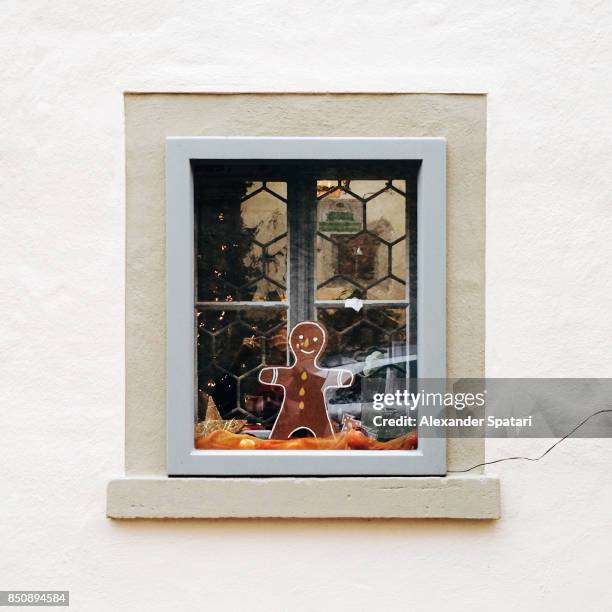 gingerbread man cookie in the window - gingerbread town stock pictures, royalty-free photos & images