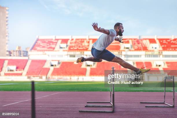 hürdenlauf - hurdles stock-fotos und bilder