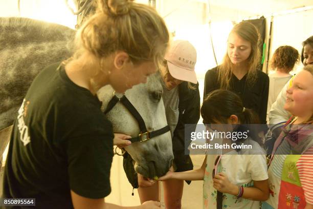 Lola Ho gets to feed the horse while teacher Jennifer Ryan watches on September 21, 2017 in Nashville, Tennessee.