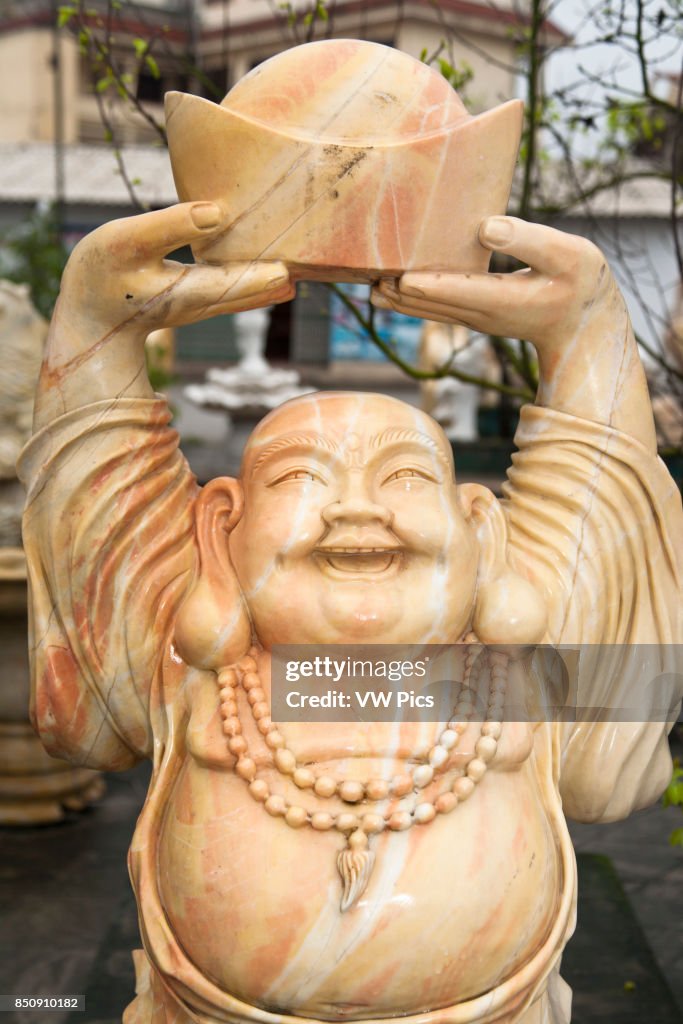 Stone carving of a happy smiling Buddha