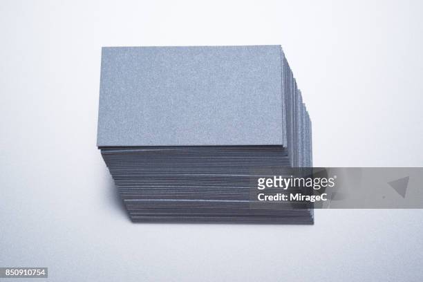 gray silver colored paper cards stacking - id cards stock-fotos und bilder