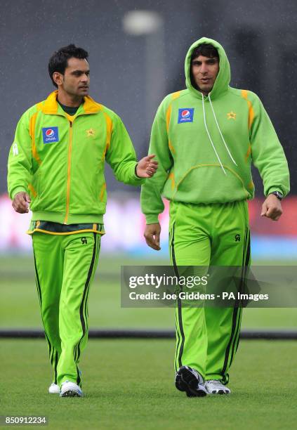 Pakistan's Muhammad Hafeez and captain Misbah ul Haq leave the field as rain falls before the ICC Champions Trophy Warm Up match at Edgbaston,...