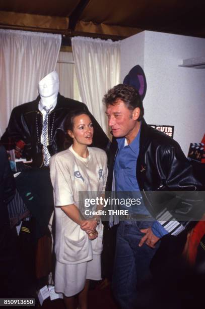 Johnny Hallyday présente sa marque de blousons en compagnie de son amie Gisèle Galante à Paris le 4 février 1988, France.