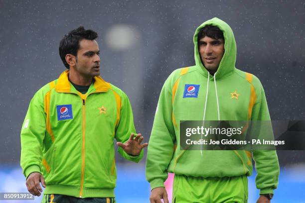 Pakistan's Muhammad Hafeez and captain Misbah ul Haq leave the field as rain falls before the ICC Champions Trophy Warm Up match at Edgbaston,...