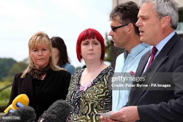 Coral and Paul Jones , the parents of April Jones listen as Ed Beltrami, Chief Crown Prosecutor for CPS Wales , reads a statement outside Mold Crown...