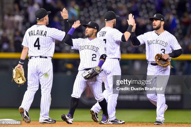 Colorado Rockies, from left, Pat Valaika, Alexi Amarista, Trevor Story, and Mike Tauchman celebrate after a 16-0 win over the Colorado Rockies at...