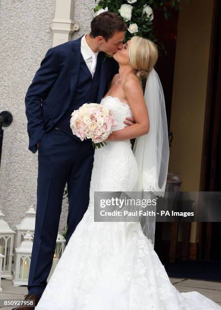 Manchester United footballer Jonny Evans and Helen McConnell kiss after their wedding at Clough Presbyterian Church, County Down.