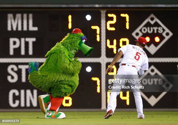 The Phillie Phanatic streaks past right fielder Nick Williams of the Philadelphia Phillies during a game against the Los Angeles Dodgers at Citizens...