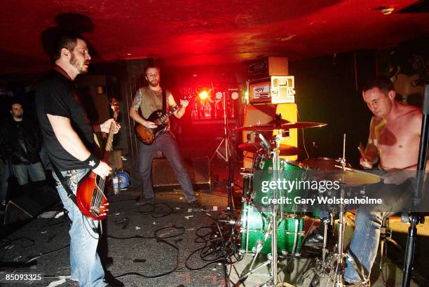 Photo of TAINT and Chris WEST and James 'Jimbob' ISAAC and Alex HARRIES, L-R Chris West, James 'Jimbob' Isaac and Alex Harries performing on stage