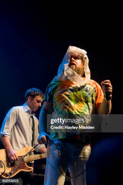 Photo of LES SAVY FAV and Tim HARRINGTON, Tim Harrington, with Syd Butler behind, performing live onstage on the NME Brats Tour 2008, with toilet...