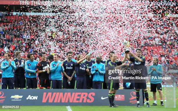 Real Madrid's Fernando Hierro and Emilio Butragueno lift the trophy after their team 2-1 win against Manchester United during the Legends Match at...