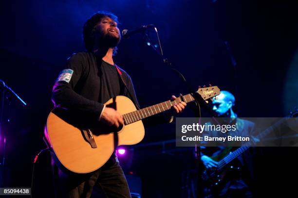 Photo of KING CREOSOTE, Kenny Anderson performing on stage, playing acoustic guitar