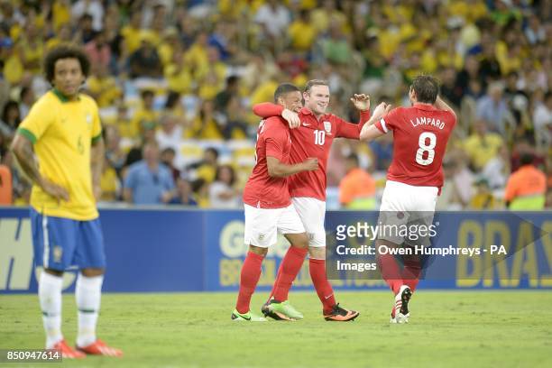 England's Wayne Rooney celebrates scoring their second goal of the game with team-mates Alex Oxlade-Chamberlain and Frank Lampard , as Brazil's Lucas...