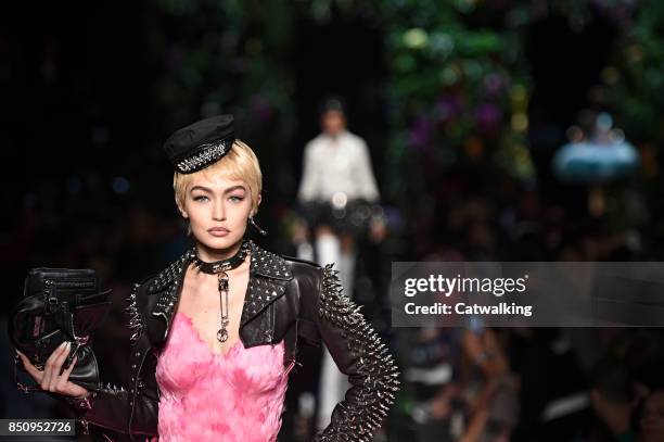 Supermodel Gigi Hadid walks the runway at the Moschino Spring Summer 2018 fashion show during Milan Fashion Week on September 21, 2017 in Milan,...