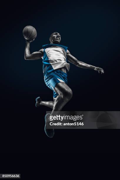 the african man basketball player jumping with ball - basketball uniform stock pictures, royalty-free photos & images